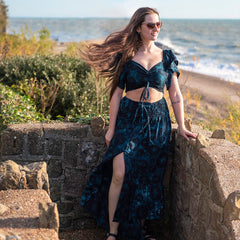 Girl at the beach wearing teal bardot top and matching skirt