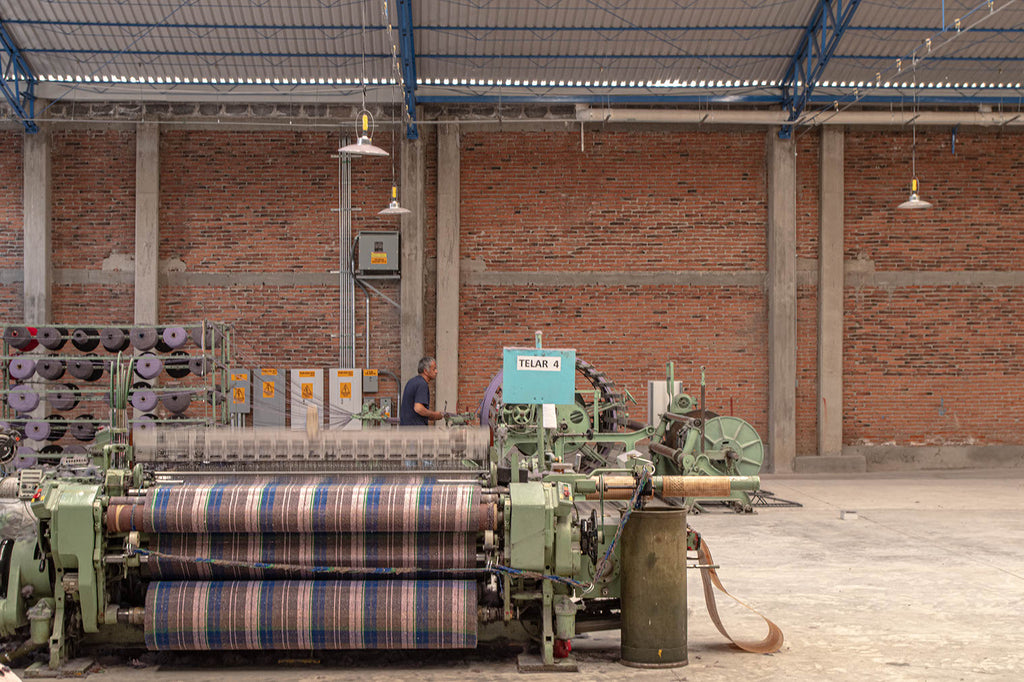 A machine that weaves jerga material for Baja Hoodies in Mexico.