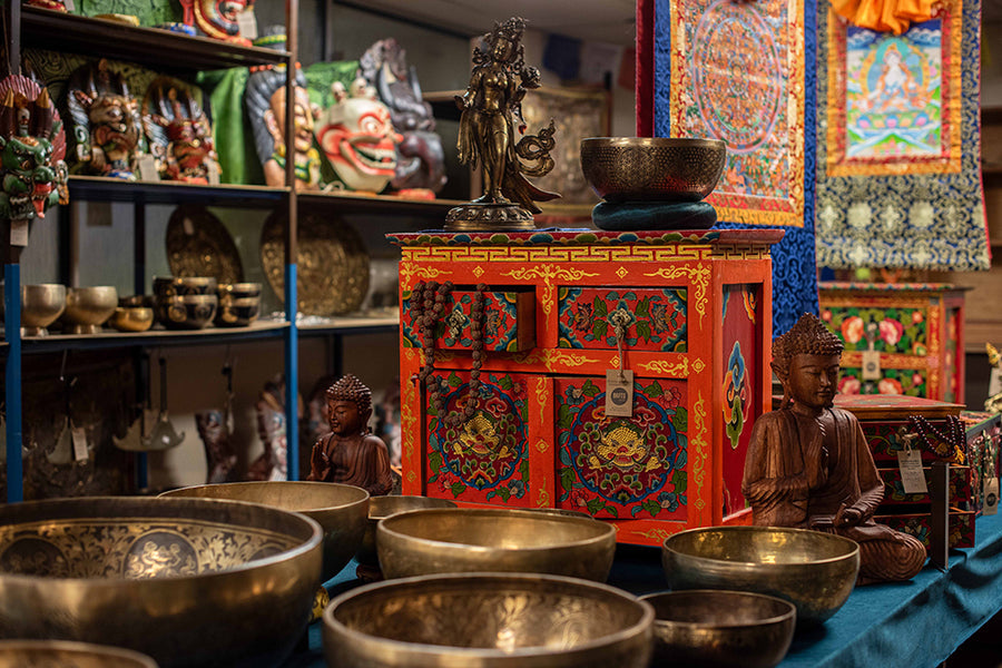 A showroom filled with Buddhist artefacts, singing bowls and carved masks.